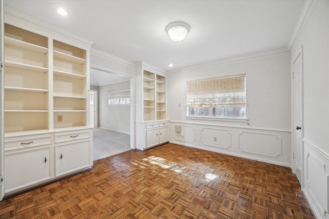 interior space with dark parquet flooring, plenty of natural light, and crown molding