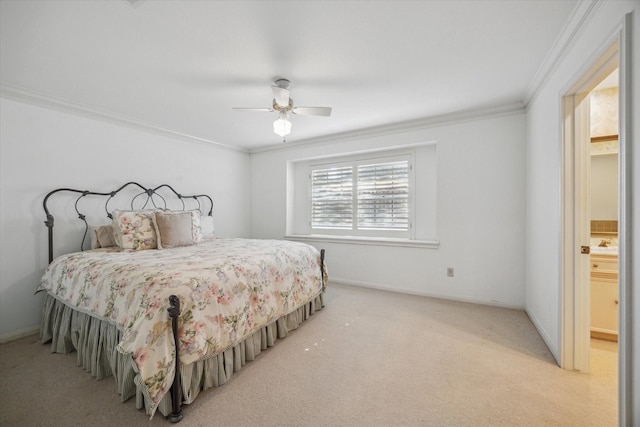 carpeted bedroom with connected bathroom, ceiling fan, and ornamental molding