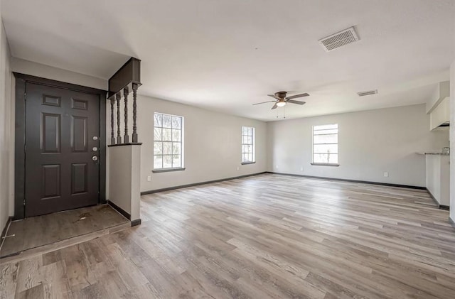 foyer with ceiling fan and light hardwood / wood-style floors