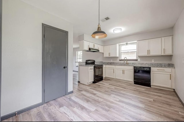 kitchen with light stone countertops, white cabinetry, black appliances, and decorative light fixtures