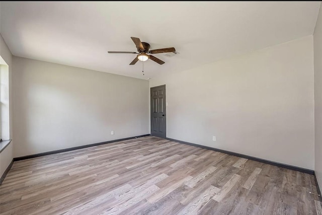 spare room featuring ceiling fan and light hardwood / wood-style flooring