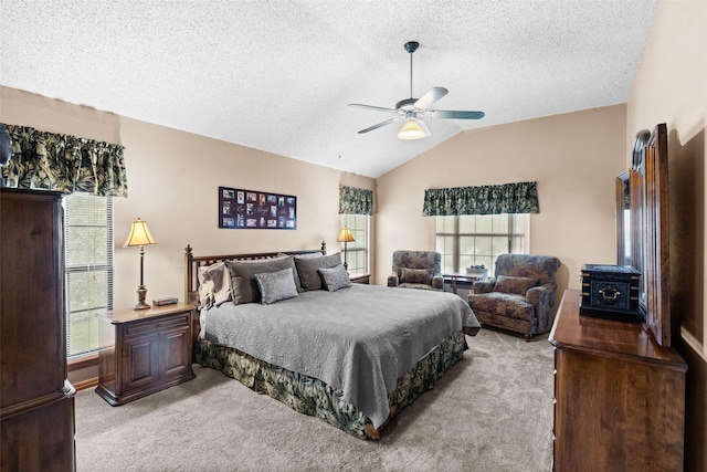 bedroom with ceiling fan, light colored carpet, vaulted ceiling, and a textured ceiling