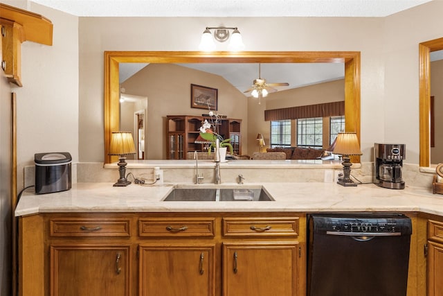 kitchen featuring ceiling fan, lofted ceiling, sink, black dishwasher, and light stone counters