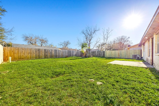 view of yard with a patio and central air condition unit