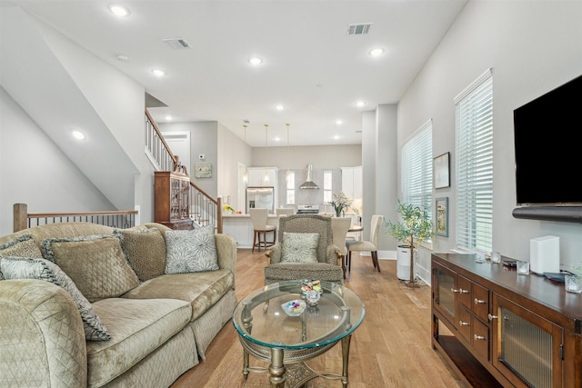 living room featuring visible vents, recessed lighting, light wood-type flooring, and baseboards