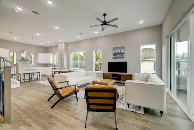 living area featuring visible vents, recessed lighting, light wood-type flooring, and ceiling fan