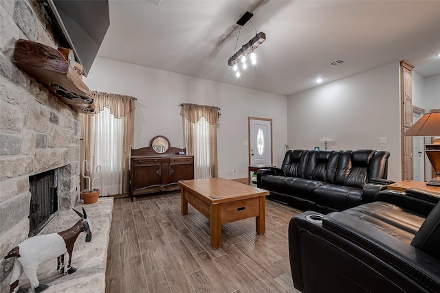 living room featuring a stone fireplace