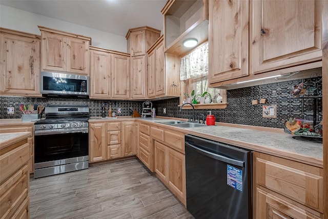 kitchen featuring decorative backsplash, light brown cabinets, sink, and appliances with stainless steel finishes