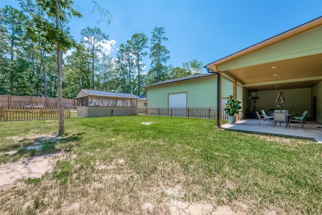 view of yard with an outbuilding and a patio