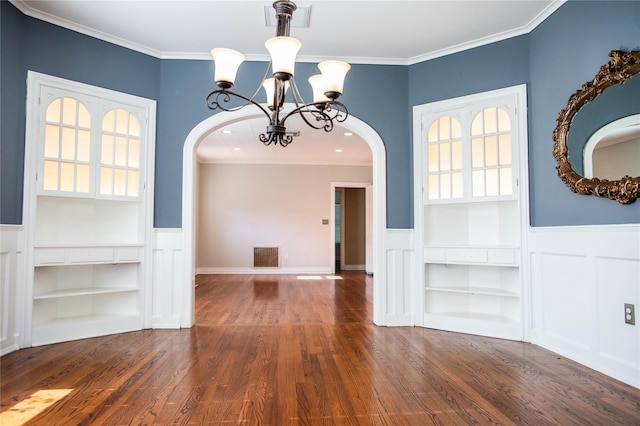 unfurnished dining area featuring dark hardwood / wood-style flooring, crown molding, and built in features