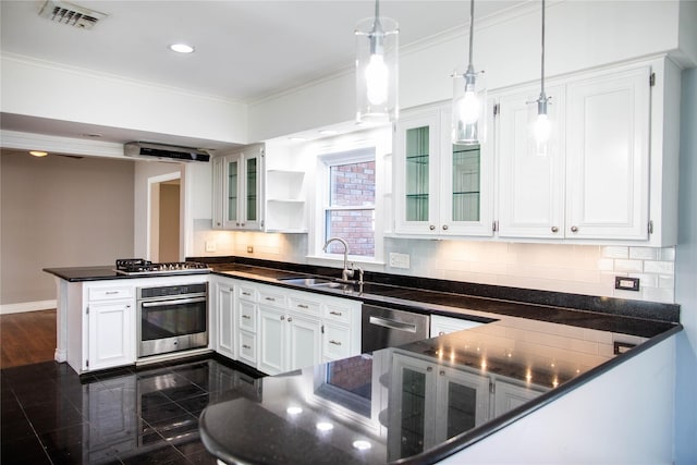 kitchen featuring kitchen peninsula, stainless steel appliances, sink, decorative light fixtures, and white cabinetry