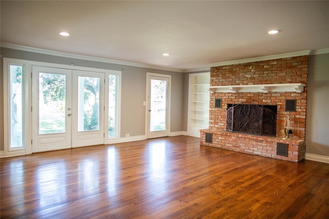 unfurnished living room with a fireplace, wood-type flooring, and ornamental molding