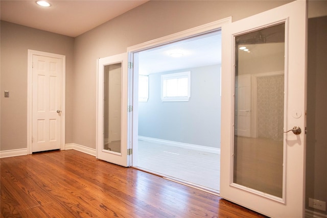 interior space with french doors and wood-type flooring