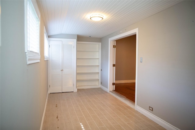 hall with light wood-type flooring and built in features