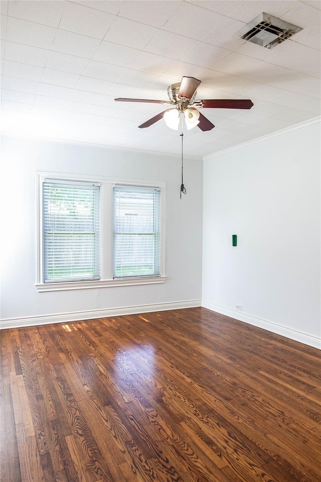 spare room with dark hardwood / wood-style floors, ceiling fan, and ornamental molding