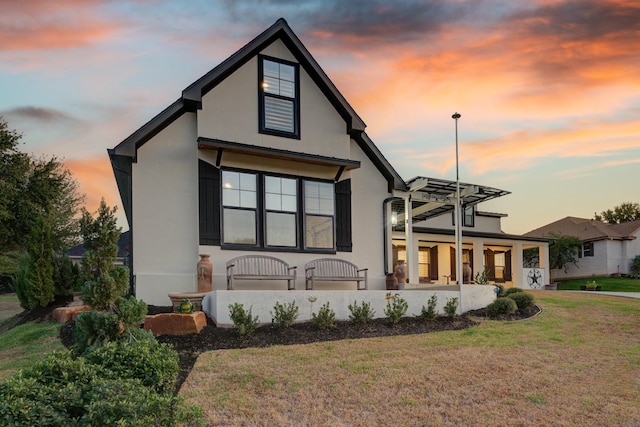 view of front of house featuring a porch and a yard