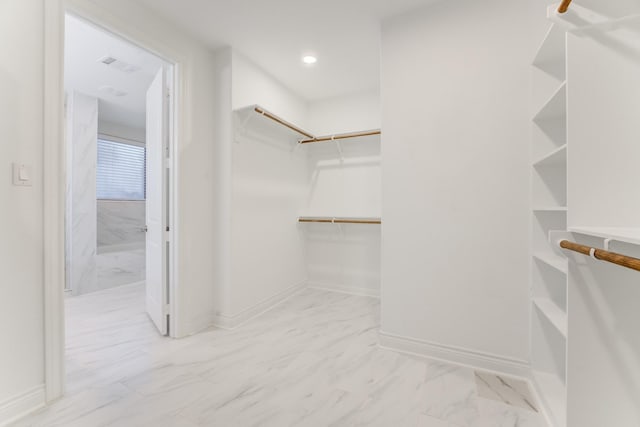 walk in closet with marble finish floor and visible vents