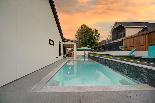 view of pool at dusk