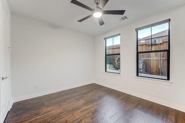 spare room featuring ceiling fan and dark hardwood / wood-style flooring