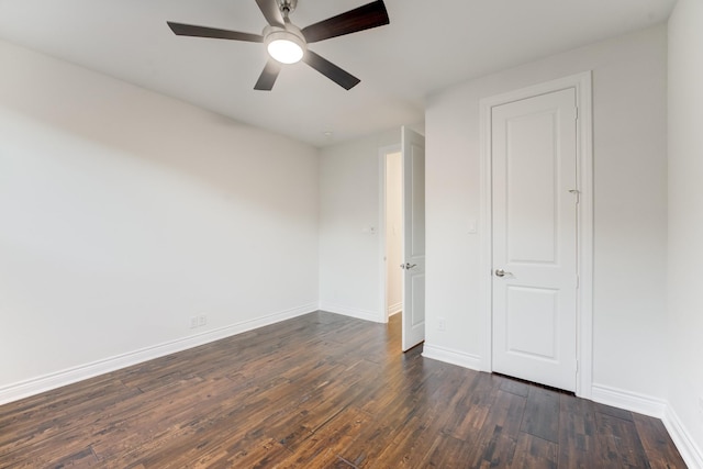 unfurnished bedroom featuring dark wood-style floors, ceiling fan, and baseboards