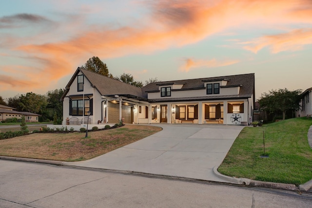 view of front of home with covered porch and a lawn