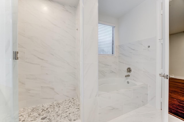 full bath featuring a garden tub and a shower stall