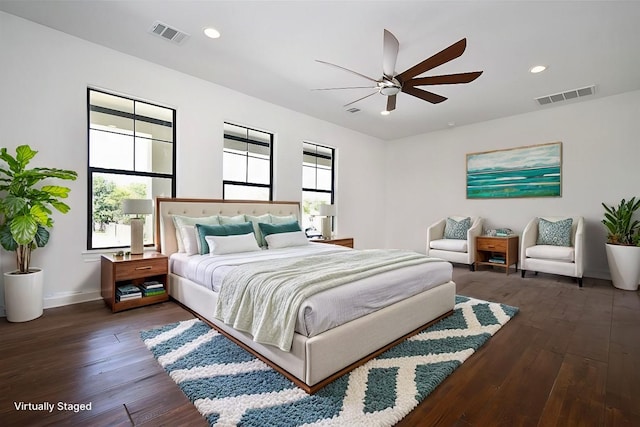 bedroom with ceiling fan, dark hardwood / wood-style floors, and multiple windows