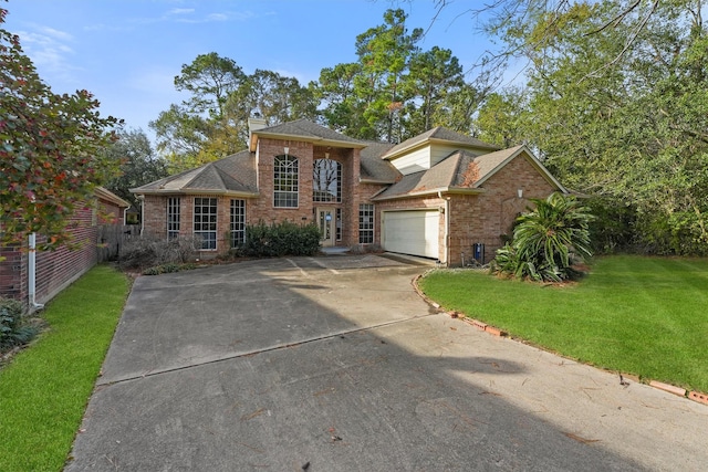 view of front of home featuring a front yard and a garage