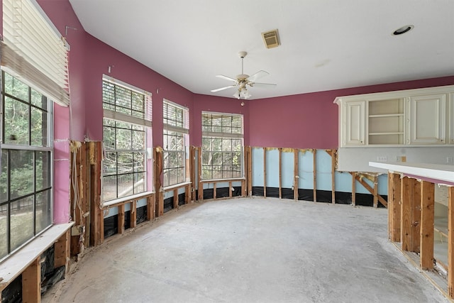 interior space with ceiling fan