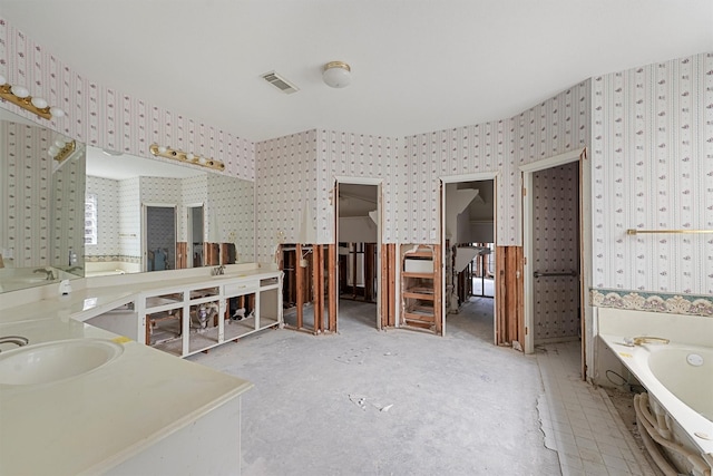 bathroom with a bathing tub and vanity