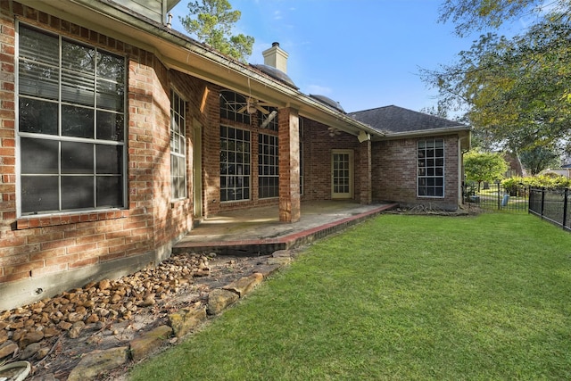 back of house featuring a patio area and a yard