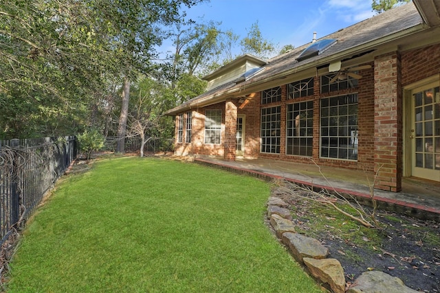 view of yard featuring ceiling fan and a patio area