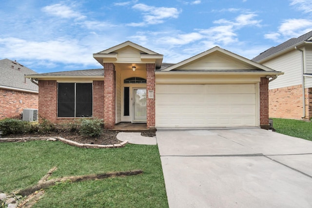 single story home with a front lawn, central AC unit, and a garage