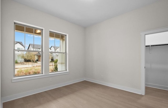 unfurnished bedroom featuring light wood-type flooring and a closet