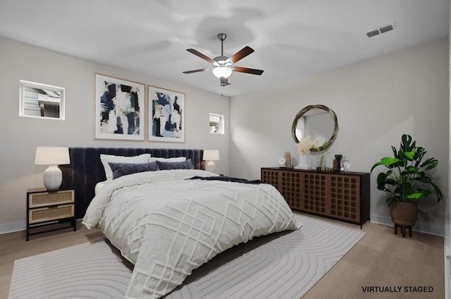 bedroom with ceiling fan and light wood-type flooring