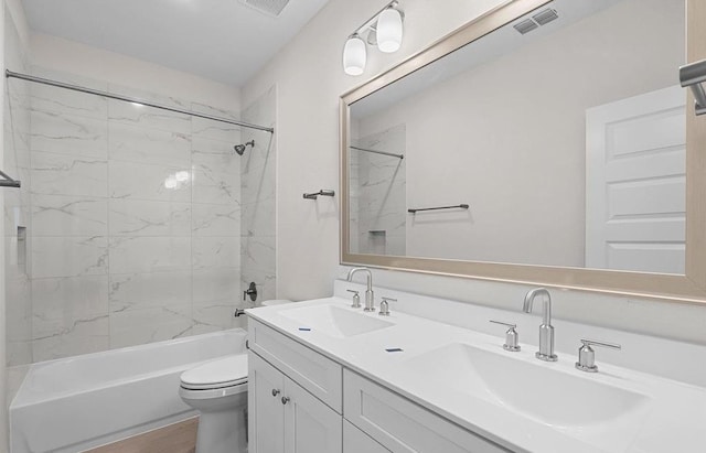 full bathroom featuring wood-type flooring, vanity, toilet, and tiled shower / bath