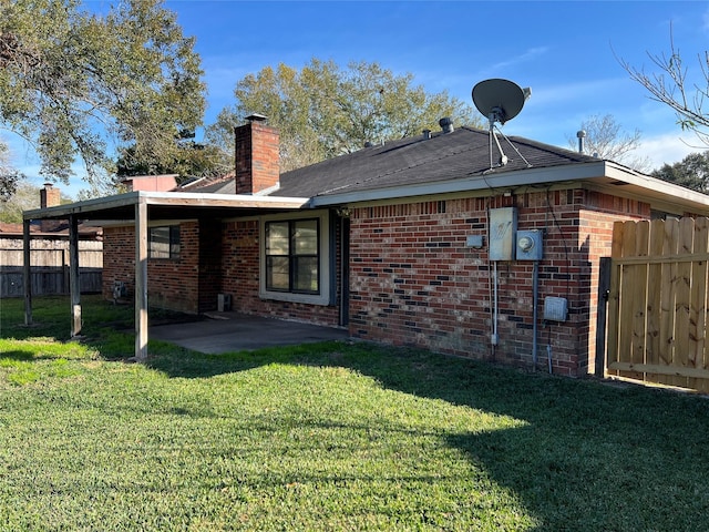 back of house featuring a yard and a patio area