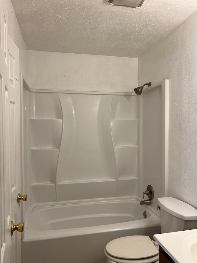 full bathroom featuring vanity, toilet, a textured ceiling, and bathing tub / shower combination