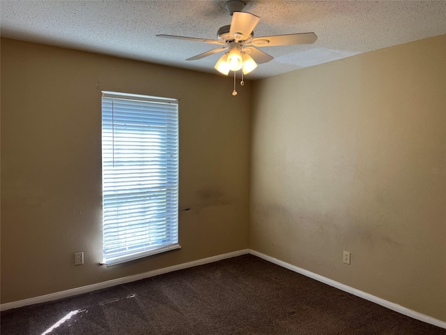 carpeted empty room featuring ceiling fan and a textured ceiling