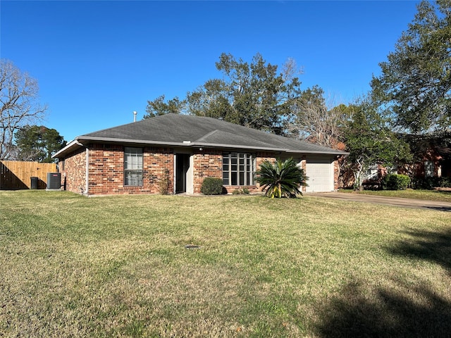 view of front of property featuring cooling unit, a garage, and a front yard