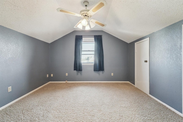 bonus room featuring ceiling fan, lofted ceiling, carpet flooring, and a textured ceiling