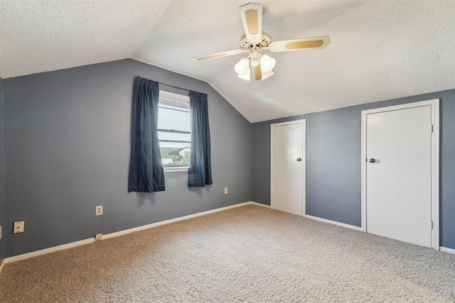 bonus room with vaulted ceiling, carpet floors, ceiling fan, and a textured ceiling