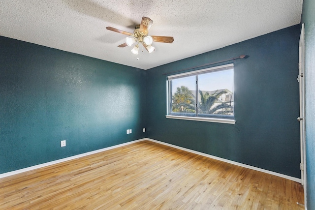 unfurnished room with hardwood / wood-style flooring, ceiling fan, and a textured ceiling