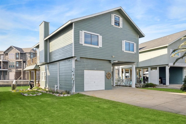 view of front of property featuring a garage and a front lawn