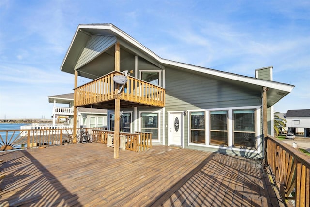 wooden terrace featuring a water view