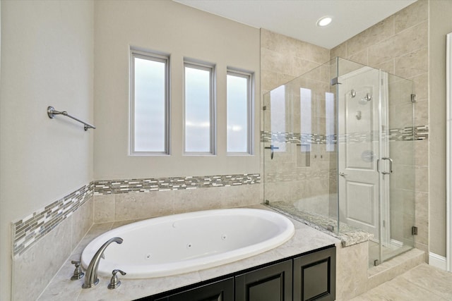 bathroom featuring shower with separate bathtub