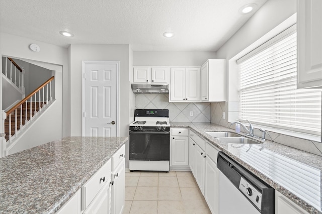 kitchen featuring dishwashing machine, white cabinetry, sink, and white stove