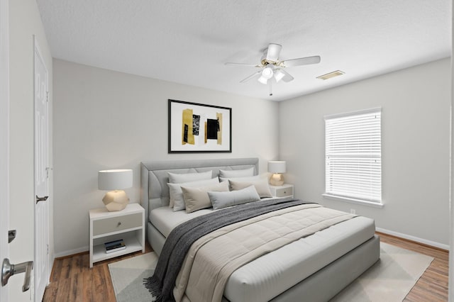 bedroom featuring ceiling fan and dark hardwood / wood-style flooring