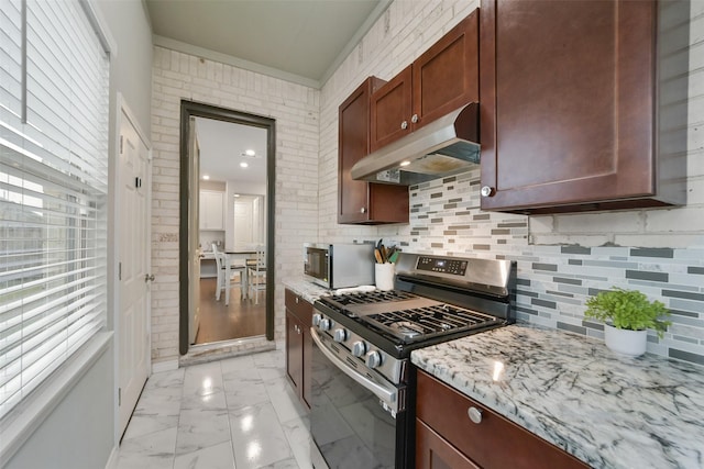 kitchen with decorative backsplash, light stone countertops, and stainless steel range with gas stovetop