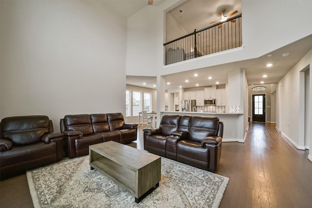 living room with wood-type flooring and a high ceiling